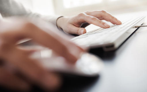 Education Services photo, close up of hands typing on keyboard.