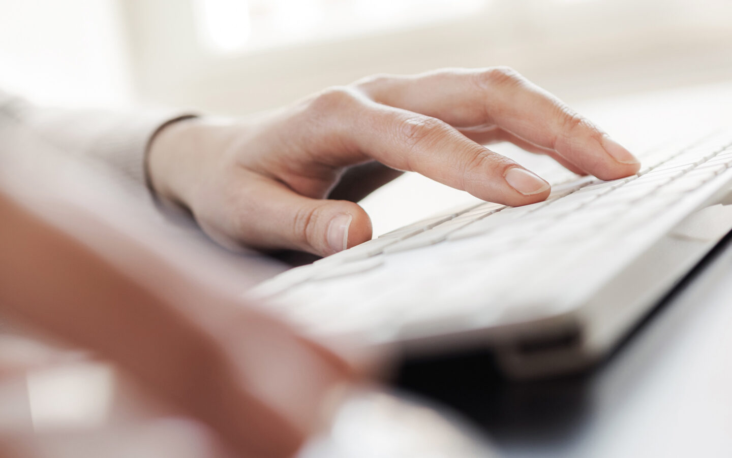 Education Services, person typing on keyboard.